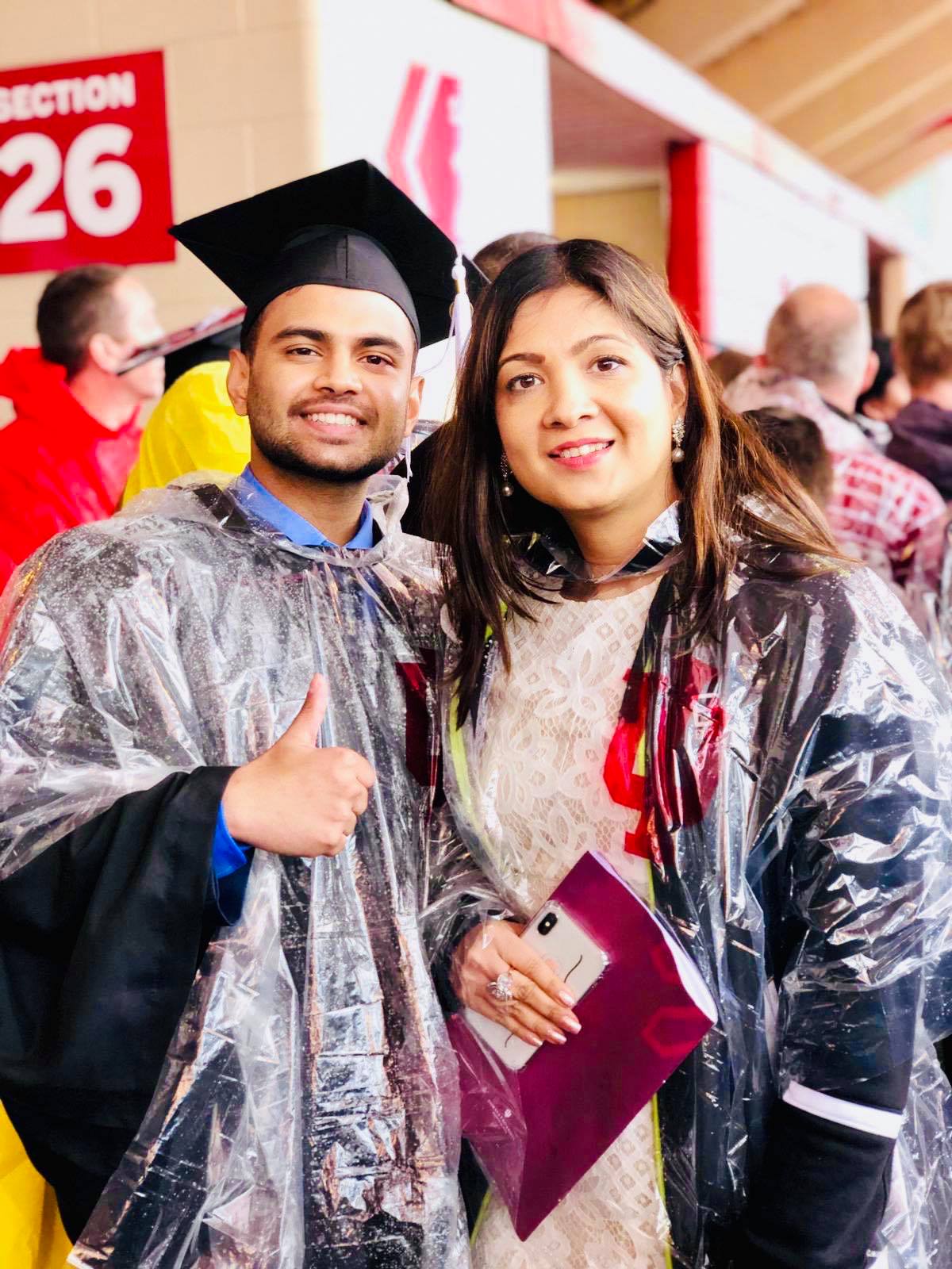 Ashutosh-and-mother-at-graduation-in-ponchos.jpg