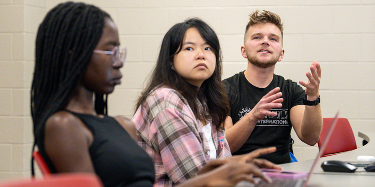 Three students sitting in a row