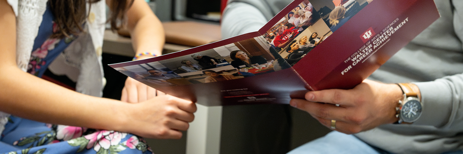 Student and advisor looking at Walter Center information