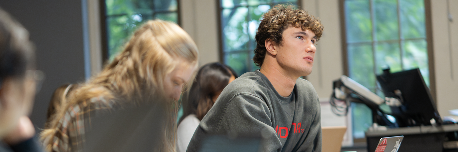 Student looking up in front of classroom